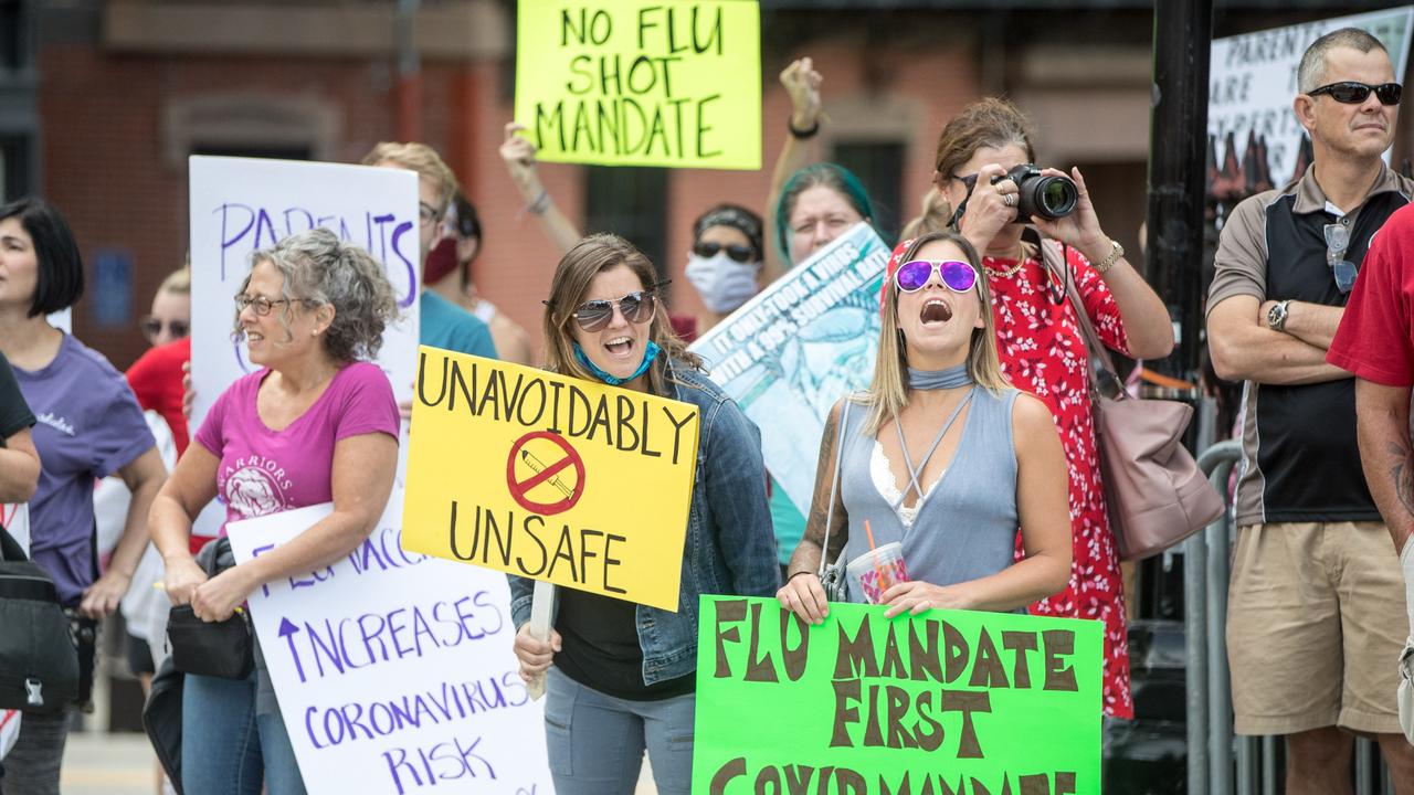 Anti-vaccine activists hold signs. Picture: Scott Eisen/Getty Images