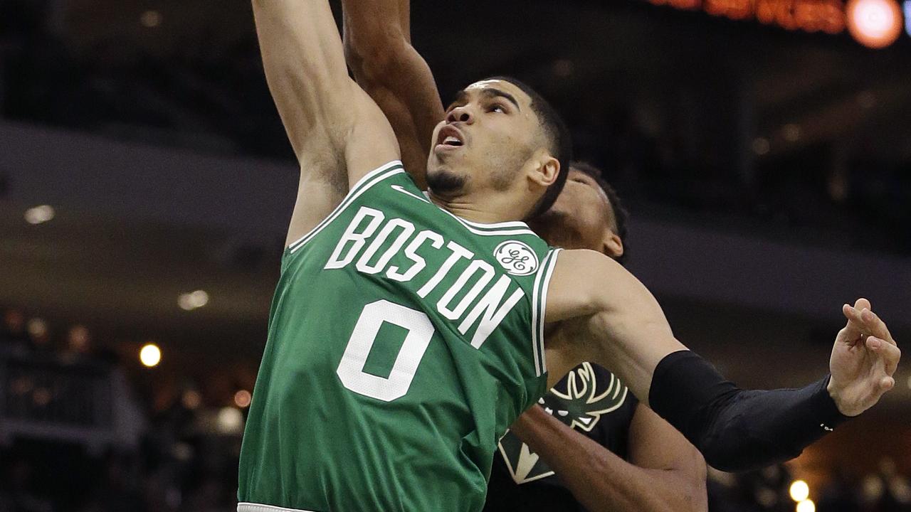 Boston Celtics' Jayson Tatum (0) is blocked by Milwaukee Bucks' Giannis Antetokounmpo.