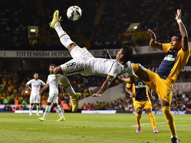 Tottenham Hotspur's Brazilian midfielder Paulinho (L) tries an overhead shot.