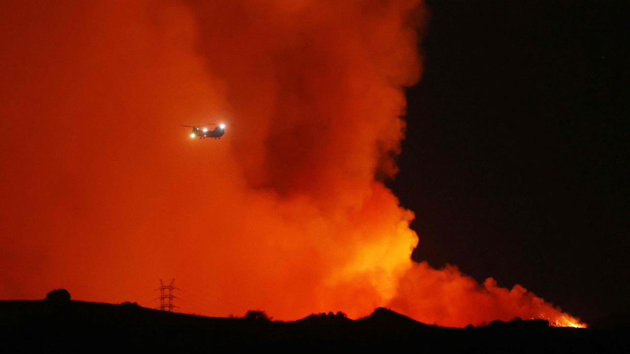 A helicopter passes as the Palisades Fire grows near Encino Hills, California. Picture: David Swanson / AFP