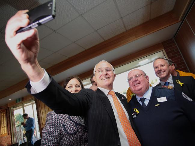 Prime Minister Malcolm Turnbull takes selfies at a round table discussion with Volunteer Fire Brigade Victoria and Country Fire Authority members at the Highton Bowls Club on June 23, 2016 in Geelong, Australia. The Coalition Government’s $20 million jobs and investment package is aimed at boosting local enterprise and employment pathways for local workers, as well as turning Avalon Airport into an international airport. (Photo by Stefan Postles/Getty Images)