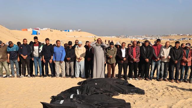 Palestinians mourn near the bodies of relatives before a burial in Rafah which was meant to be a safe zone. Picture: AFP