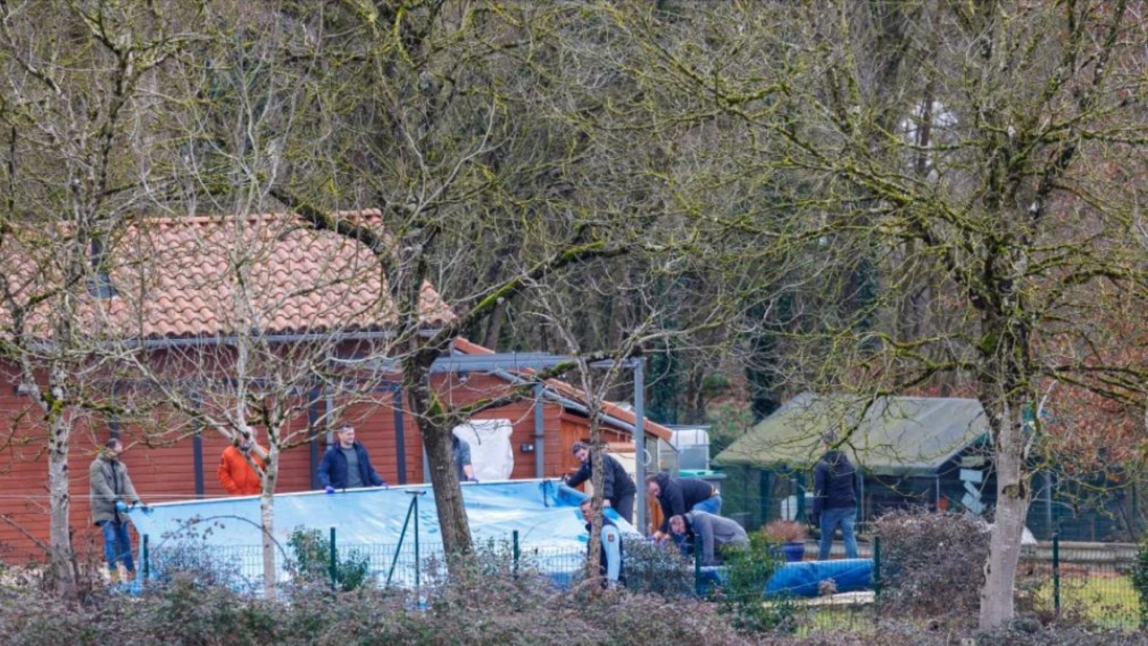 Police search the property. Picture: Doug Seeburg