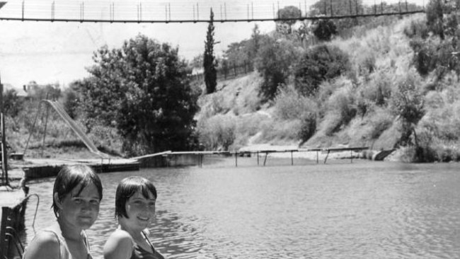 The bridge holds many memories for many people. This picture, taken by Jack Haywurst in 1967, shows young friends at the Gilberton Swimming Pool in 1967, with the suspension bridge n the background.