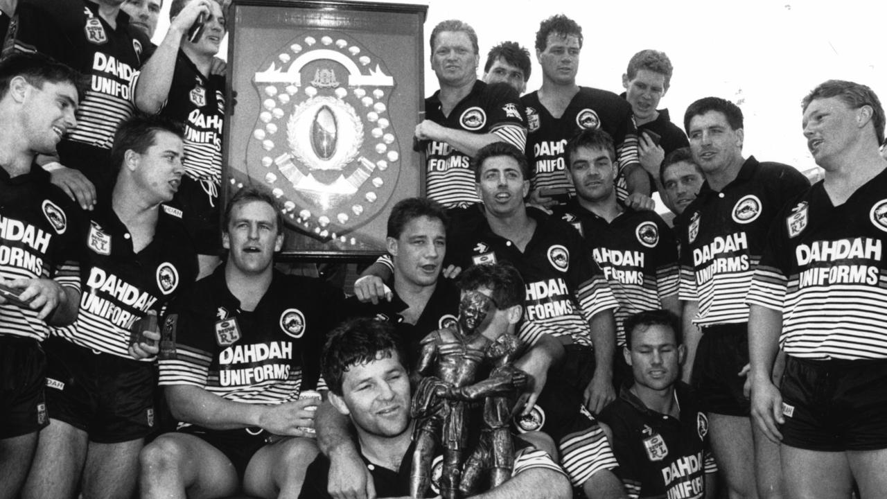 Royce Simmons holds the Winfield Cup as he and Penrith Panthers teammates celebrate after defeating the Canberra Raiders in the 1991 Grand Final. Pic News Limited.