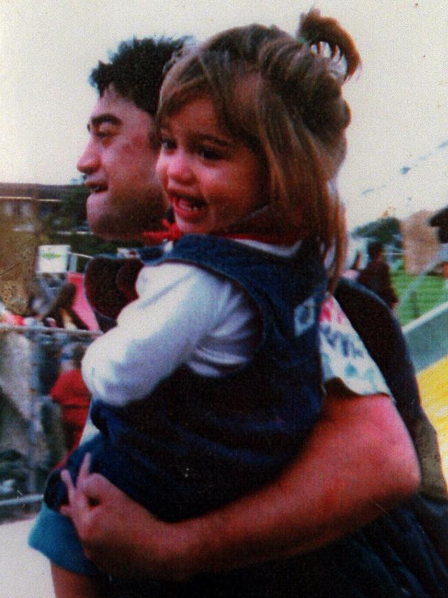 Teela pictured in her father’s arms when she was a child.