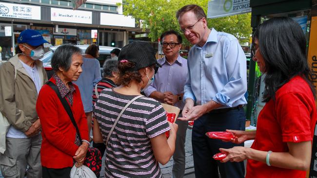 Councillor Trenton Brown, in Eastwood, Sydney, today, handing out face masks to the public. Numbers are down in Eastwood because of people’s fear of the coronavirus. Picture: Justin Lloyd