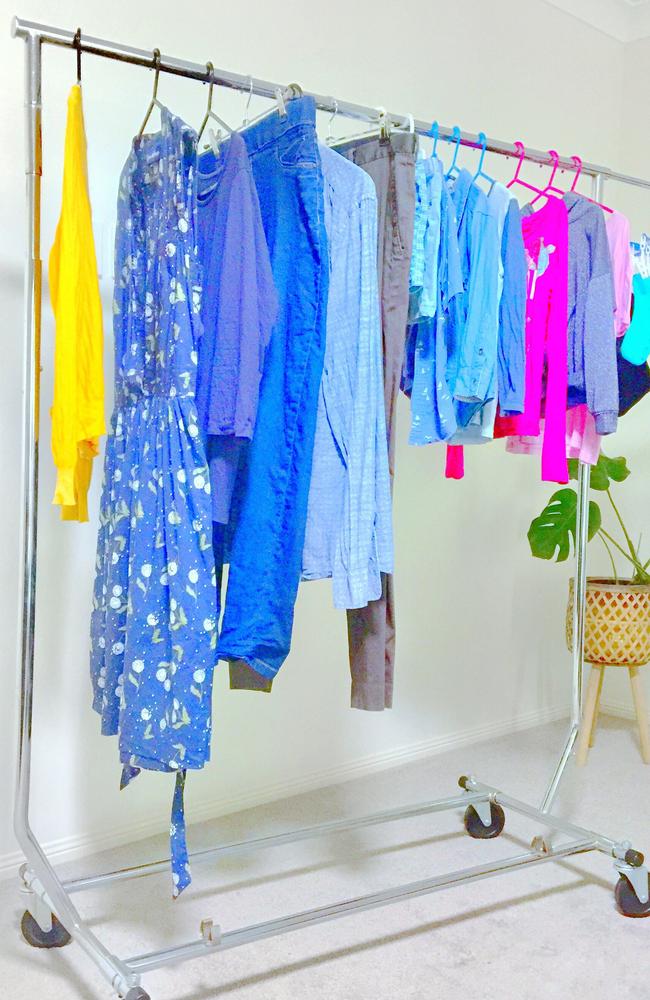 Leanne hangs all her washing on a clothes rail using different coloured hangers for her wardrobe.