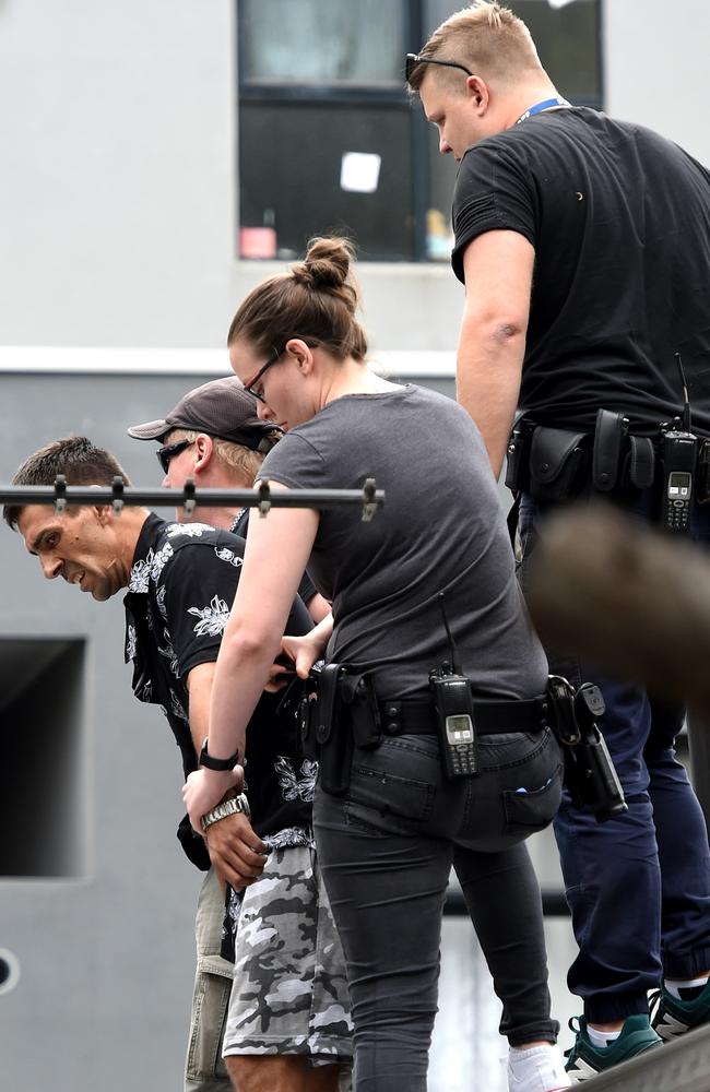 A man is arrested on a house roof after running from the scene of an accident on the corner of Main Drive and Plenty Road, Bundoora. Picture: Nicole Garmston