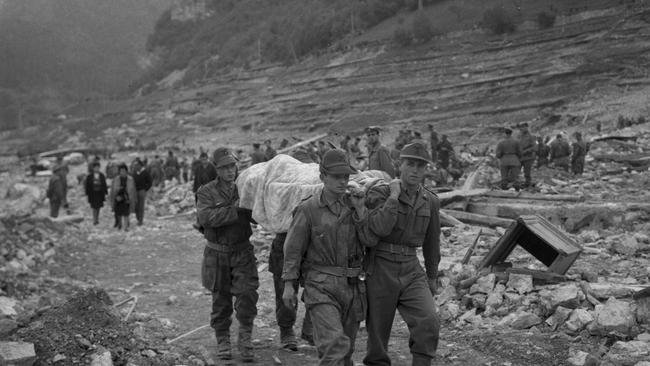 Soldiers carry a corpse on a gurney along a pathway, Longarone, near the Vajont Dam in the Piave Valley, Italy, early October, 1963. Picture: Getty Images