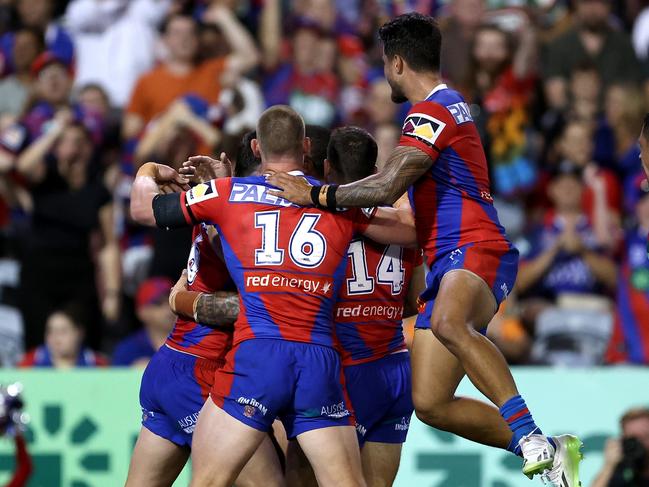 Newcastle celebrate a try to veteran backrower Tyson Frizell.