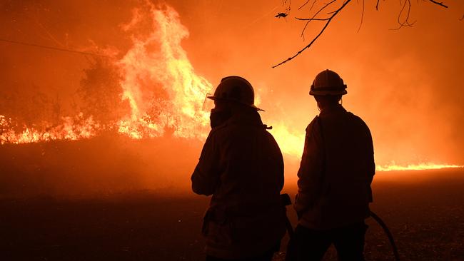 NSW Rural Fire Service crews protect properties on Kellyknack Road on Thursday. Picture: AAP