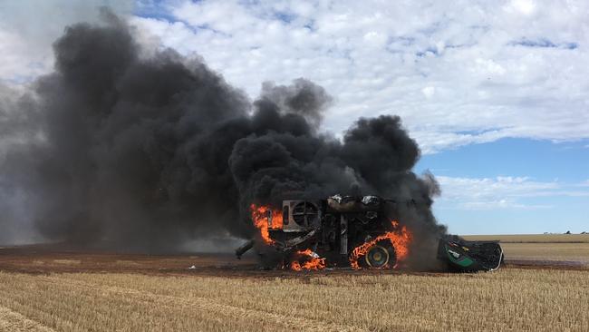 A John Deere grain harvester goes up in smoke at a Meatian farm.