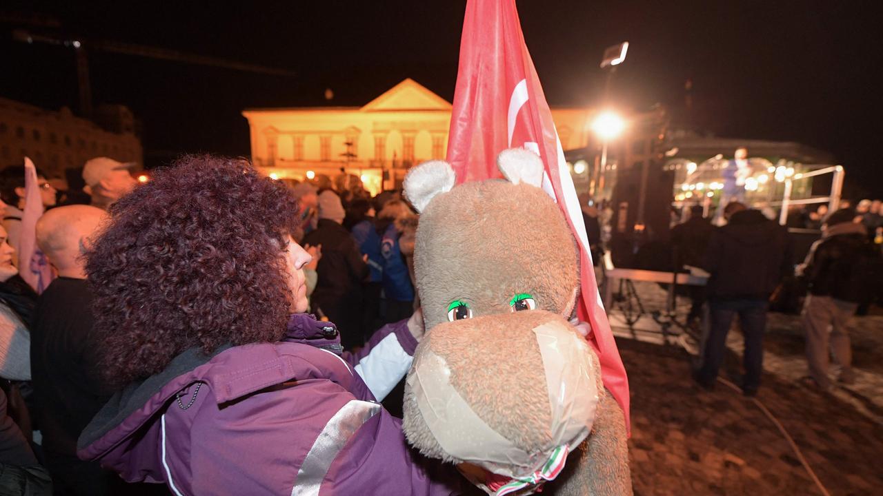 A protester with a cuddly toy protests against the controversial pardoning. Picture: Ferenc ISZA / AFP