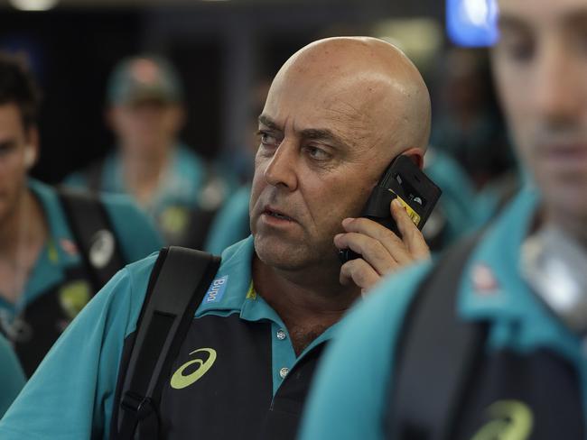 Australia's coach Darren Lehmann talks on the phone, after the arrival of the Australian team