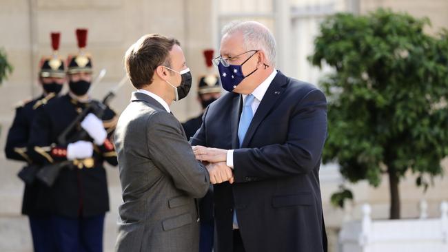 Prime Minister Scott Morrison and French President Emmanuel Macron embrace during a meeting in Paris in June. Picture: Adam Taylor/PMO