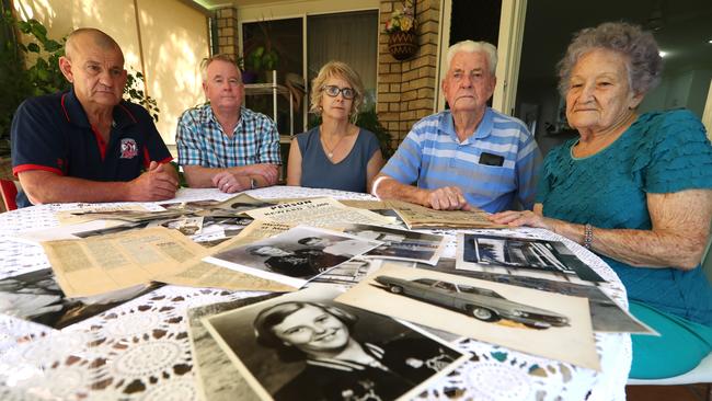 Marilyn's brothers David and Rex and sister Lenore with mother and father John and Daphne Wallman, look at period newspaper cuttings police photographs and reward notices from the time when daughter schoolgirl Marilyn Wallman disappeared in 1972. Photo: Lyndon Mechielsen/The Australian