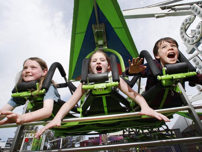 Royal Melbourne Show preview to see whatÕs on offer at this yearÕs Royal Melbourne Show. Flying like superman, joy riders Gabe 9, Emily 9 and Marley 9 on the Cliff Hanger ride for young kids.  Picture: David Caird