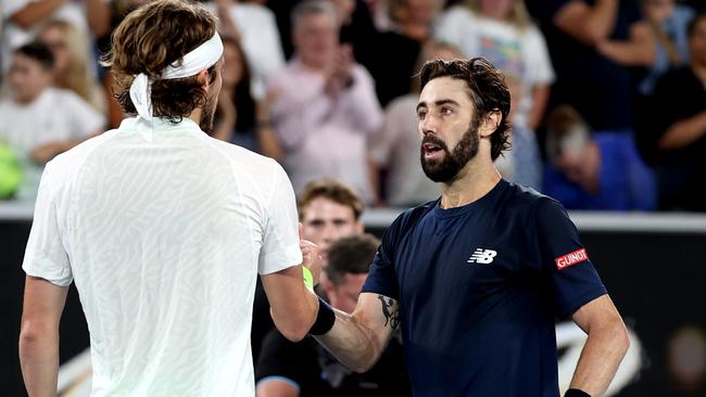 MELBOURNE, AUSTRALIA - JANUARY 17: Stefanos Tsitsipas of Greece embraces Jordan Thompson of Australia after winning his round two singles match against Jordan Thompson of Australia during the 2024 Australian Open at Melbourne Park on January 17, 2024 in Melbourne, Australia. (Photo by Julian Finney/Getty Images)