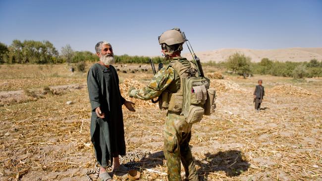 A soldier from the 2nd Mentoring Task Force searchers a local farmer during a patrol through the Mirabad Valley region in Afghanistan. Picture: Department of Defence