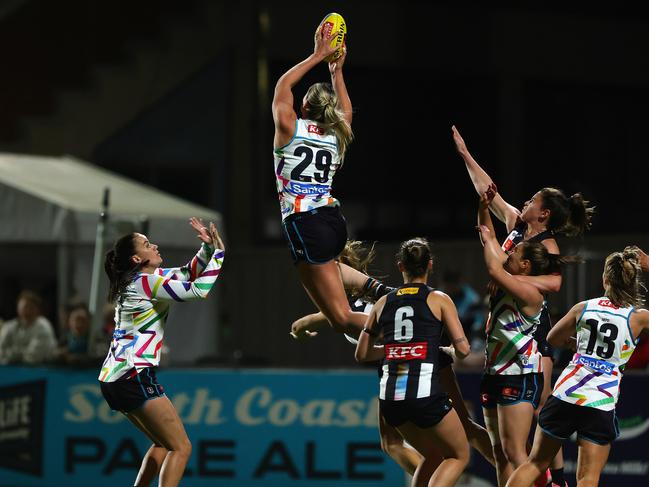 Matilda Scholz of the Power takes an absolute screamer against the Pies. Picture: Sarah Reed/AFL Photos via Getty Images.