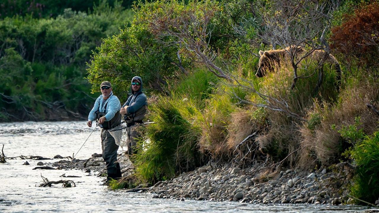 The bear lurked just metres behind the two fishermen. Picture: Robert Hawthorne/Kennedy News