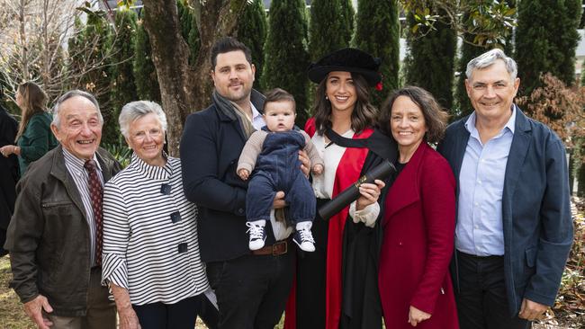 Doctor of Philosophy (Psychology) graduate Rebecca Lane with family (from left) Tony Ellwood, June Ellwood, Matt Deloraine holding Arthur Deloraine, Renee Ellwood and John Lane at a UniSQ graduation ceremony at The Empire, Tuesday, June 25, 2024. Picture: Kevin Farmer