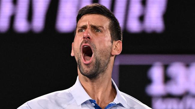 TOPSHOT - Serbia's Novak Djokovic celebrates after winning the third set against Croatia's Dino Prizmic during their men's singles match on day one of the Australian Open tennis tournament in Melbourne on January 14, 2024. (Photo by WILLIAM WEST / AFP) / -- IMAGE RESTRICTED TO EDITORIAL USE - STRICTLY NO COMMERCIAL USE --