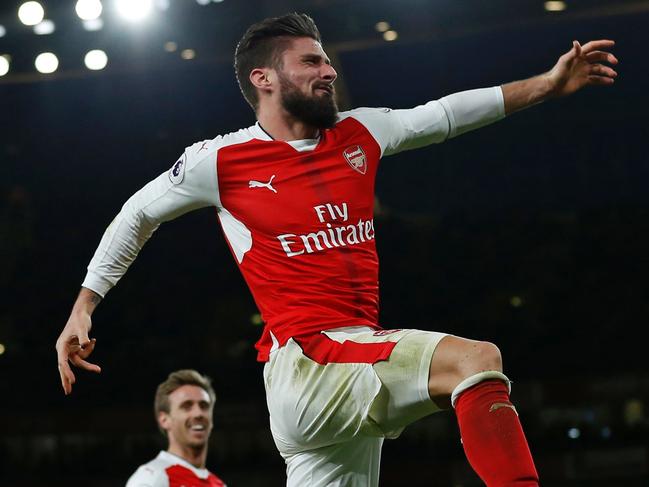 TOPSHOT - Arsenal's French striker Olivier Giroud celebrates after scoring the opening goal of the English Premier League football match between Arsenal and West Bromwich Albion at the Emirates Stadium in London on December 26, 2016. Arsenal won the game 1-0. / AFP PHOTO / IAN KINGTON / RESTRICTED TO EDITORIAL USE. No use with unauthorized audio, video, data, fixture lists, club/league logos or 'live' services. Online in-match use limited to 75 images, no video emulation. No use in betting, games or single club/league/player publications. /