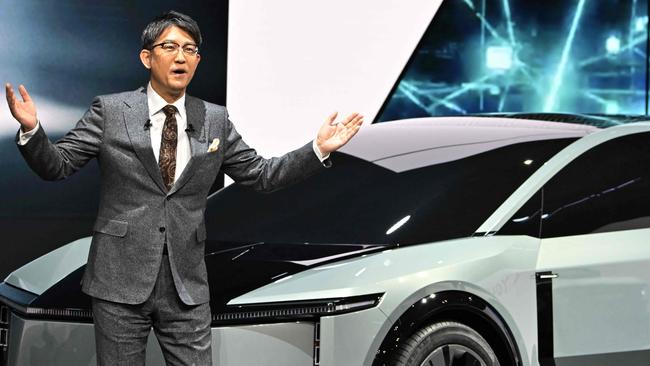 Toyota Motor President Koji Sato delivers a speech next to a FT-3e, a new electric vehicle concepts SUV, at the Japan Mobility Show 2023 in Tokyo on October 25, 2023. (Photo by AFP)