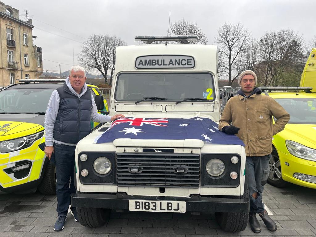 Benjamin and Neil Webster with the ambulance they donated and delivered to Ukraine. Picture: Supplied