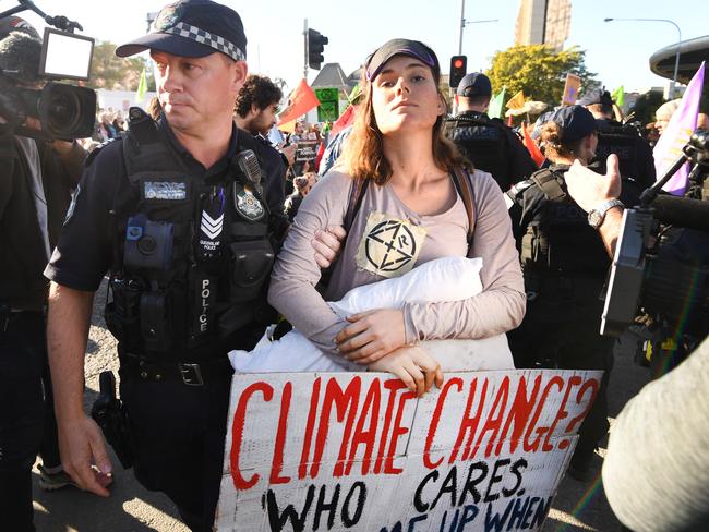 An Extinction Rebellion protestor is being arrested in Brisbane, Tuesday, August 6, 2019. Climate change protestors are planning to shut down Brisbane's CBD. (AAP Image/Dan Peled) NO ARCHIVING