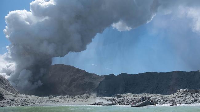 This photograph courtesy of Michael Schade shows the volcano on New Zealand's White Island spewing steam and ash minutes following the eruption.