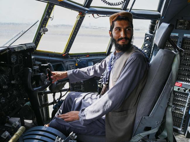 A Taliban fighter sits in the cockpit of an Afghan Air Force aircraft at the airport in Kabul. Picture: Wakil KOHSAR / AFP