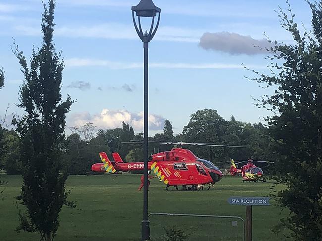 Air ambulances after landing in Forbury Gardens in the British town of Reading where three men were stabbed to death. Picture: AP