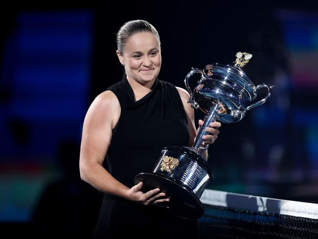 Retired former world number one Australian tennis player Ashleigh Barty carries the Daphne Akhurst Memorial Cup ahead of the womenâs singles final match between Elena Rybakina of Kazakhstan and Aryna Sabalenka from Belarus on day thirteen of the Australian Open tennis tournament in Melbourne on January 28, 2023. (Photo by Martin KEEP / AFP) / -- IMAGE RESTRICTED TO EDITORIAL USE - STRICTLY NO COMMERCIAL USE --