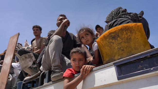 Palestinians who fled Rafah in the southern Gaza Strip ride with their belongings in the back of a truck, as they arrive to take shelter in Deir el-Balah in the central part of the Palestinian territory at the weekend. Picture: AFP