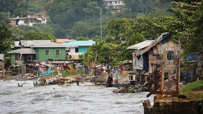 Children and families wash and swim in sewage and rubbish in Honiara, Solomon Islands. Picture: News Corp Australia