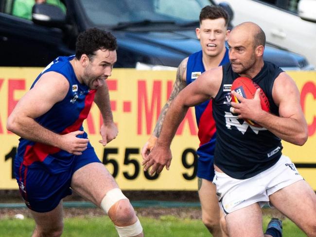 Cunnington evades two opponents. Picture: Warrnambool footy photos/Peter Goodman