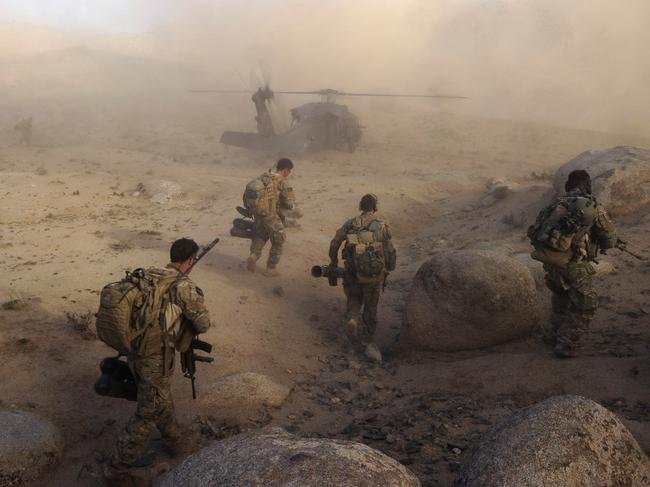 Defence Supplied Pics. Special Operations Task Group soldiers make their way to a waiting UH-60 Blackhawk helicopter after a Shura in Sha Wali Kot.Afghan National Security Forces (ANSF) partnered with Australian Special Forces from the Special Operations Task Group conducted a deliberate operation to clear a Taliban insurgent stronghold in the Shah Wali Kot region of northern Kandahar province.The Shah Wali Kot Offensive comprised synchronised and deliberate clearance operations involving Australian Commandos combined with a number of surgical helicopter-born assaults from Special Air Service (SAS) troops on key targets.Removing Taliban insurgents from Afghan communities allows the Government of Afghanistan to establish a presence and gain the trust of the community to provide them with necessary infrastructure and security that was not provided by the insurgents.