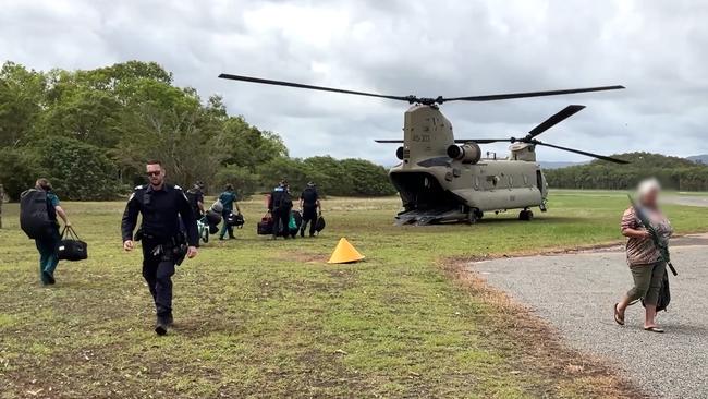 Police have released footage of evacuations from Wujal Wujal to Cooktown with the assistance of ADF Chinooks, along with images of damage to the Mulligan Highway near Cooktown. Emergency services personnel boarding a Chinook to deploy from Cooktown back to Wujal Wujal to assist with response and recovery