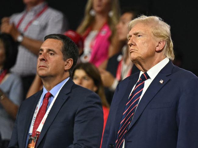 (FILES) (From L) US Rep. Devin Nunes (R-CA), US former President and 2024 Republican presidential candidate Donald Trump and North Dakota Governor Doug Burgum during the third day of the 2024 Republican National Convention at the Fiserv Forum in Milwaukee, Wisconsin, on July 17, 2024. US President-elect Donald Trump on December 14, 2024, named loyalist and former Congressman Devin Nunes, who heads his social media platform Truth Social, to serve as chairman of a White House intelligence advisory board. (Photo by Patrick T. Fallon / AFP)