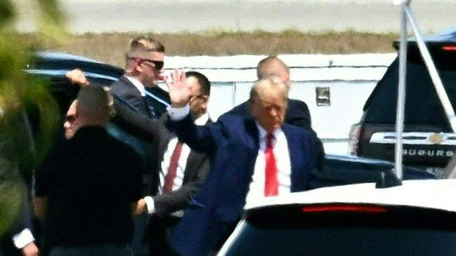 Donald Trump waves as he boards his plane at Palm Beach International Airport in West Palm Beach, Florida. Picture: AFP.