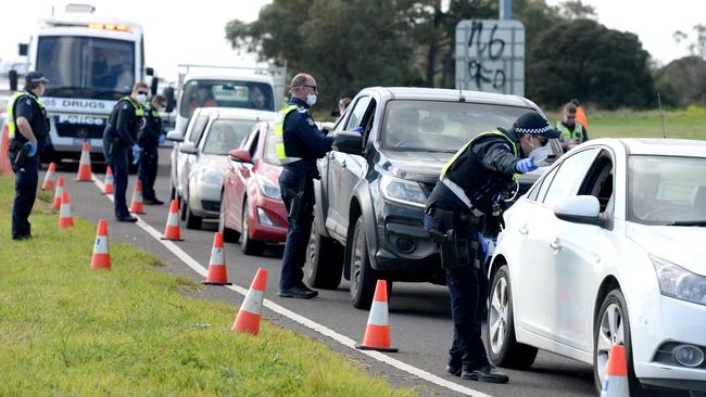 Police conduct checks of Geelong-bounds motorists on the Princes Highway at Little River. Picture: Andrew Henshaw