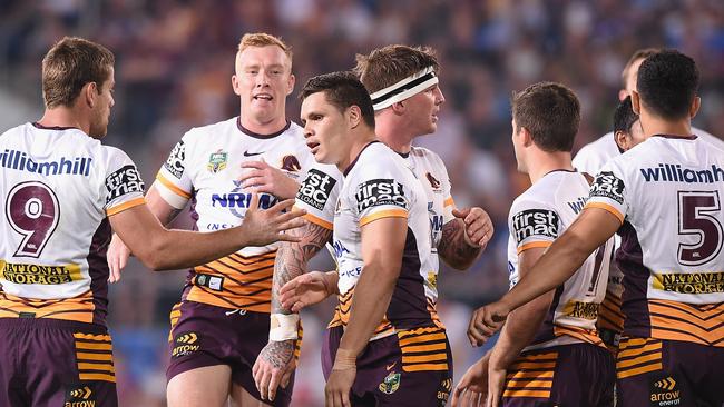 James Roberts celebrates his try with Broncos teammates.