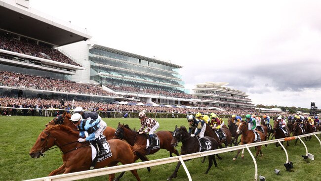 MELBOURNE, AUSTRALIA - NOVEMBER 01: The field pass the post during race seven the Lexus Melbourne Cup during 2022 Lexus Melbourne Cup Day at Flemington Racecourse on November 01, 2022 in Melbourne, Australia. (Photo by Robert Cianflone/Getty Images)