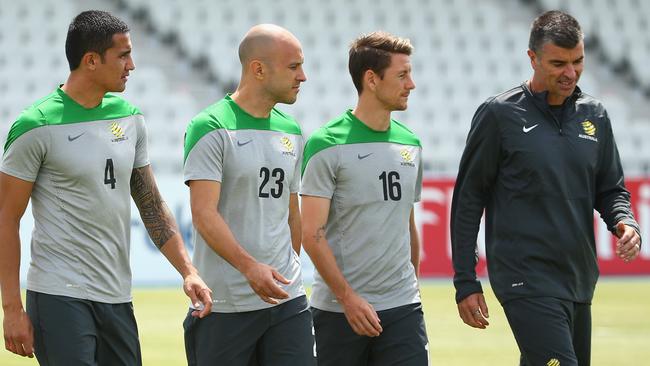 Tim Cahill, Mark Bresciano and Nathan Burns get down to work at Socceroos training.