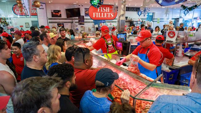 Christmas Eve shoppers at Sydney Fish Markets on Tuesday. The RBA says consumer have remained resilient.Picture: Justin Lloyd.