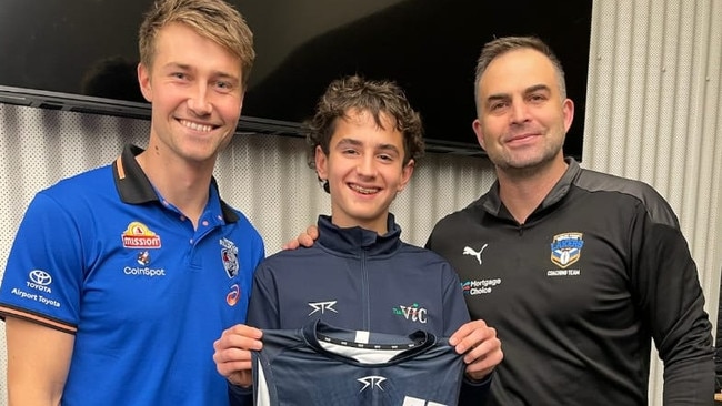 Kristian Fitzsimmons (middle) is presented with his Big V jersey. Picture: Echuca Football Netball Club.