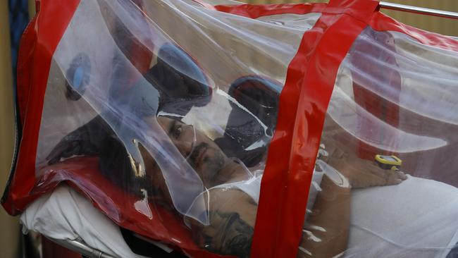 A patient encased in a protective plastic tube arrives at Mexico General Hospital, in Mexico City on Tuesday. Picture: AP